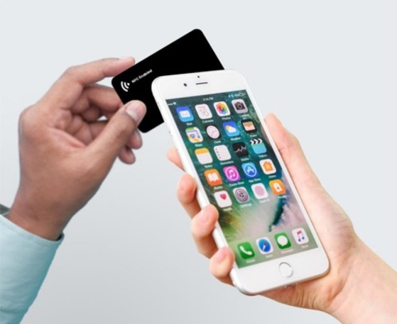 Tapping an NFC business card against a smartphone to share contact details